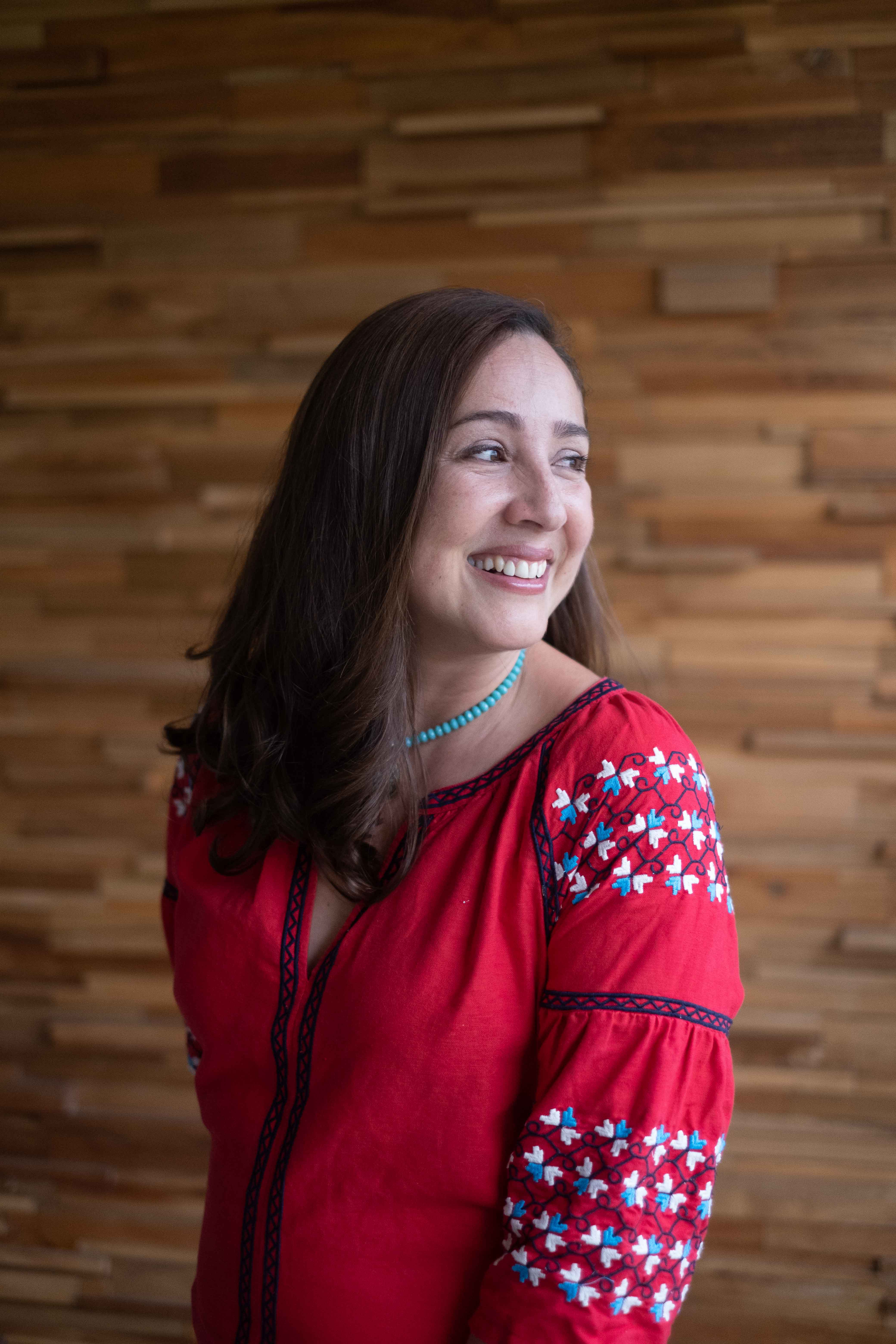 Vanessa Valenzuela smiling in a warm, natural portrait