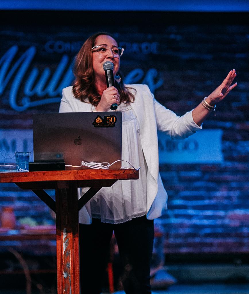 Vanessa speaking to an audience on stage